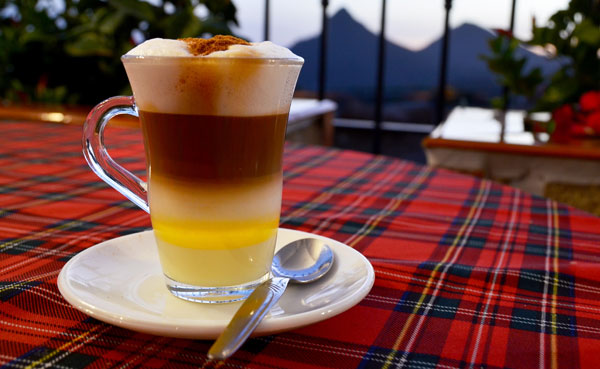 Carajillo oder Barraquito mit Eierlikör Glas mit verschiedenen geschichteten Flüssigkeiten: Kaffee, Eierlikör, Milchschaum usw.